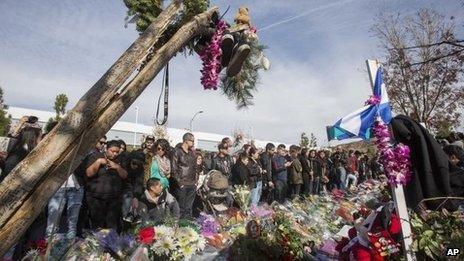 Fans crowd the scene of a memorial rally and car cruise to remember actor Paul Walker and his friend Roger Rodas