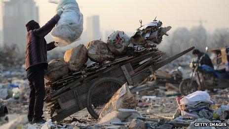 A woman scavenges for rubbish in China