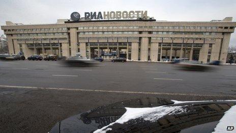 Cars pass by the former Russian RIA Novosti information agency headquarters in Moscow, Russia, Monday, Dec. 9, 2013.