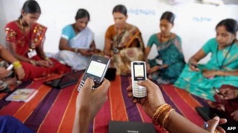 Women using mobile phones in India