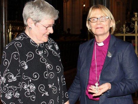 Julia Turner presents her mother's silver cross to Bishop Pat Storey, the first woman to be consecrated as a Church of Ireland bishop