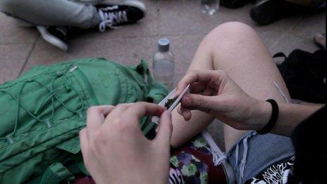 A man rolls a joint in Montevideo