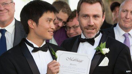 A couple hold their marriage certificate after being married at Canberra's Old Parliament House in Australia, 7 December 2013