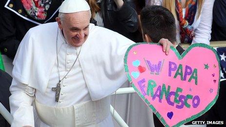 Pope Francis acknowledges the crowd from an open-air jeep ahead of his weekly audience in St Peter's Square on 27 March.