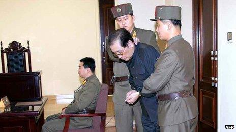 Chang Song-thaek (second right) being escorted in court on 12 December 2013