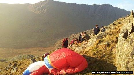 Rescuers help the paraglider