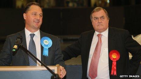 The newly elected Humberside Police and Crime Commissioner Matthew Grove (L) makes his victory speech as runner-up former deputy prime minister Lord Prescott looks on