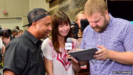 People gathered around a computer screen