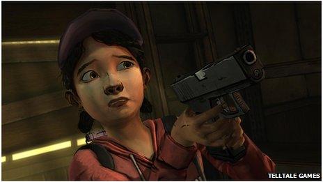 Clementine holds a gun