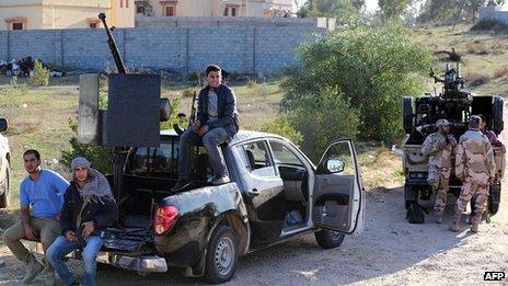 Members of the Tripoli Rebels Brigade militia patrol a main road in Tajura. 16 Dec 2013