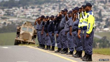 Police officers line the road in Mthatha, in the Eastern Cape, as part of a rehearsal for Nelson Mandela's funeral