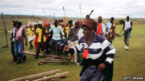 A Xhosa woman sings and dances as young men take part in a manhood ceremony in Qunu ahead of Nelson Mandela's funeral on Sunday