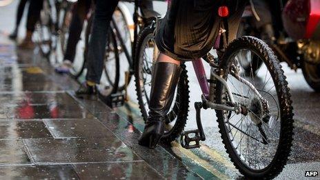 cyclists wait at traffic lights