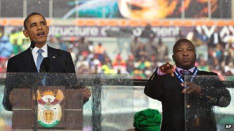 President Barack Obama and sign interpreter Thamsanqa Jantjie at FNB Stadium in Soweto on 10 December