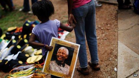 Girl with picture of Nelson Mandela in Pretoria on 11 December