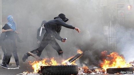 Masked protesters take part in a demonstration to demand changes in the state education system in Valparaiso city on 18 October, 2013