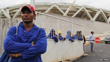 Workers gather outside the Arena Amazonia building site, in Manaus, Brazil