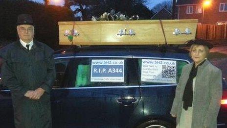 Campaigners against traffic levels on the A303 in Wiltshire drive a coffin mounted on a car