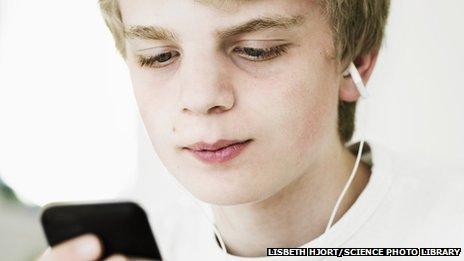 boy listing to music using his phone