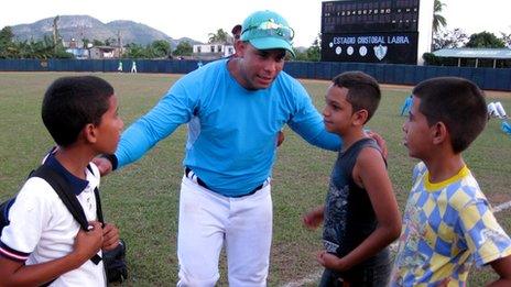 Michel Enriquez speaks to some young fans during a match in December 2013