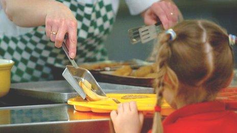 Girl being served school meal