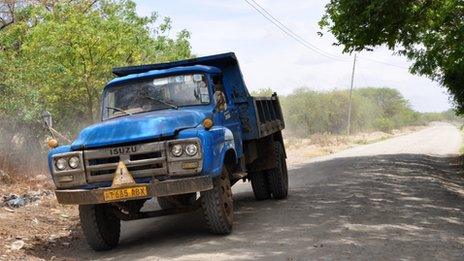 Truck by side of a road in the Serengeti