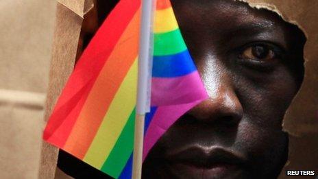 An asylum seeker from Uganda covers his face with a paper bag in order to protect his identity as he marches with the LGBT Asylum Support Task Force during the Gay Pride Parade in Boston, Massachusetts June 8, 2013.