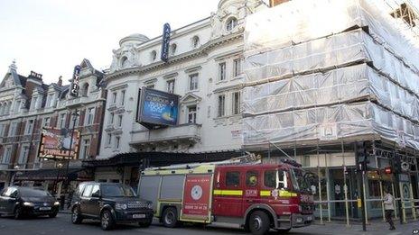 A fire brigade truck waits outside The Apollo Theatre