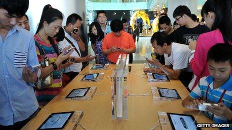 Customers looking at iPhones at an Apple store in China