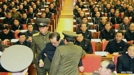 Television footage released on 9 December 2013 shows Chang Song-thaek being forcibly removed by uniformed personnel from a meeting of the Political Bureau of the Central Committee of the Workers' Party of Korea in Pyongyang