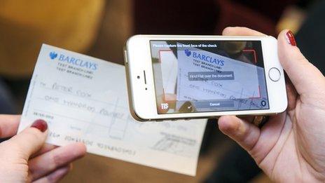 woman photographs cheque