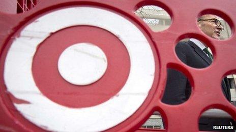 US Senator Charles Schumer, is pictured through a Target shopping cart, as he holds a news conference about the massive credit card hack that has affected 40 million Target customers 22 December 2013