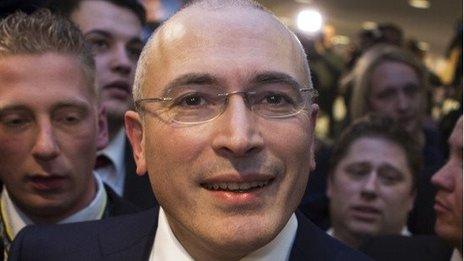 Mikhail Khodorkovsky leaves a press conference in Berlin.