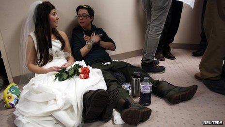 Heather Collins (L) and her partner Jax Collins wait in line with hundreds of other applicants for a marriage license at the Salt Lake County Clerks office in Salt Lake City, Utah, 23 December 2013