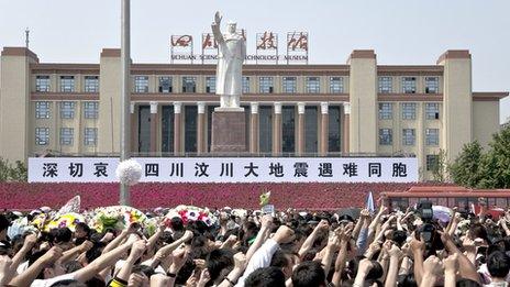 People gathered in the square to remember victims of the 2008 Sichuan Earthquake a week earlier, Chengdu Tianfu Square, 19 May 2008. This Mao Zedong statue was built in 1969.