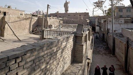 A 24-metre tall Mao statue, built in 1968, stands at the gate of a Uighur community, Kashgar, Xinjiang