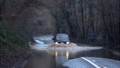 Van on flooded road