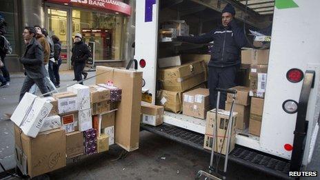 A FedEx delivery man prepares to deliver packages in New York on 24 December