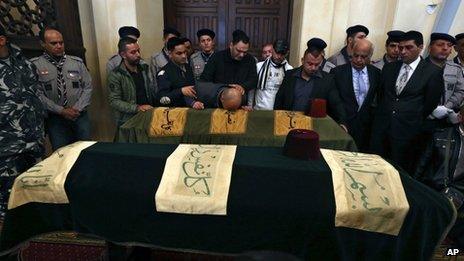 Relatives mourn over the coffins of Mohammed Chatah and his aides in downtown Beirut, Lebanon, Sunday 29 December