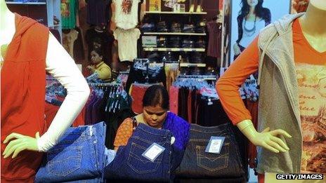 A woman browsing jeans in a shop in India