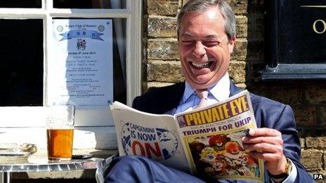 UKIP leader Nigel Farage laughs while reading a copy of Private Eye in May