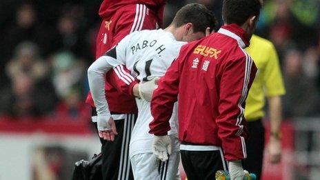 Swansea City's Pablo Hernandez is helped off the field