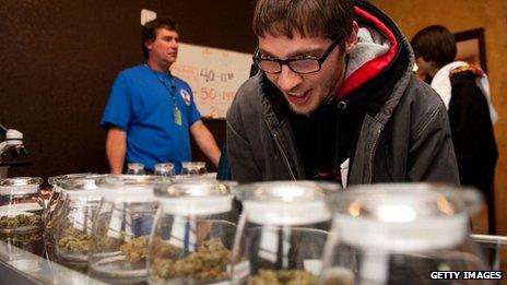 A cannabis buyer selects strains at a Denver dispensary