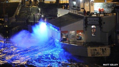 Waves crash over a Plymouth seafront restaurant