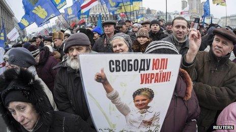 Pro-European integration supporters hold a image of jailed opposition leader Yulia Tymoshenko during a rally in Independence square in central Kiev 5 January 2014