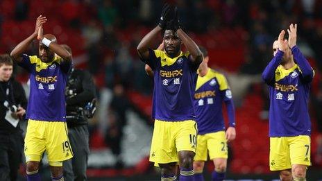 Swansea City players clap their fans at Old Trafford