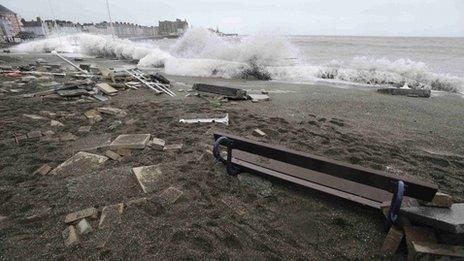 A large wave crashes over the promenade at high tide in Aberystwyth