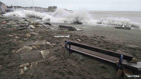 A large wave crashes over the promenade at high tide in Aberystwyth