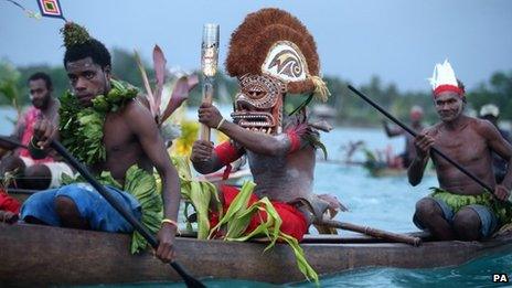 The Queen"s Baton being transported by wooden canoe from Kavieng to Nusa island in Papua New Guinea in October 2013