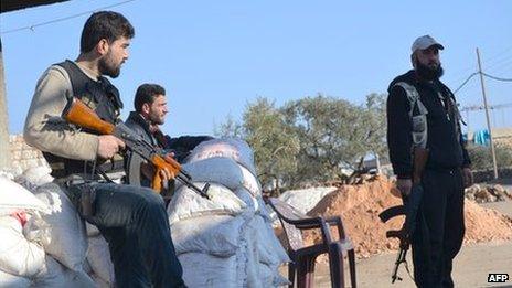 Rebel fighters man a checkpoint close to Jabal al-Zawiya in Idlib province on 6 January 2014